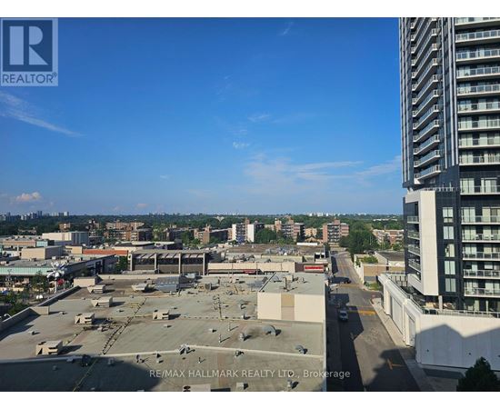 A view of a cityscape from a high vantage point, with a clear blue sky above.