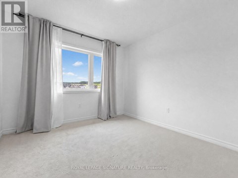 A room with a large window and curtains.
