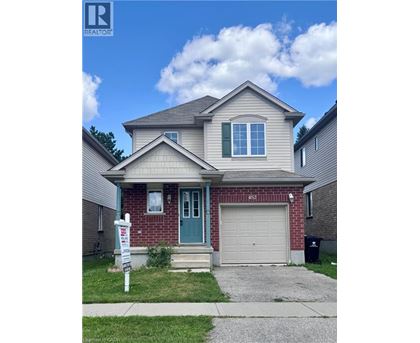 A house with a blue door and a garage door is for sale.