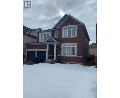 A house with a snow-covered front yard.