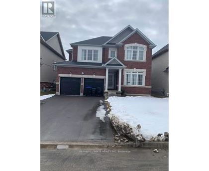 A house with a garage and a driveway in front of it.