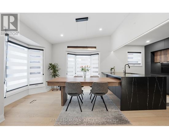 A modern kitchen with a dining table and chairs.