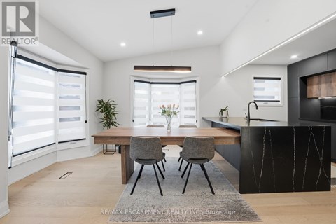 A modern kitchen with a dining table and chairs.
