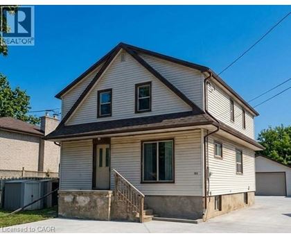 A two-story house with a garage on the side.