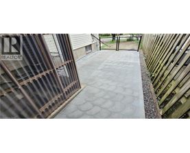 A concrete walkway with a pattern of circles leading to a gate.