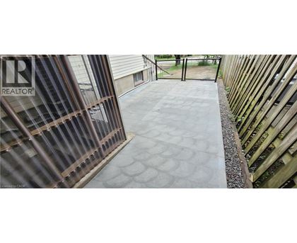 A concrete walkway with a pattern of circles leading to a gate.