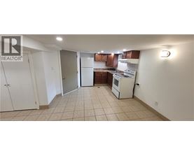 A kitchen with white appliances and brown cabinets.