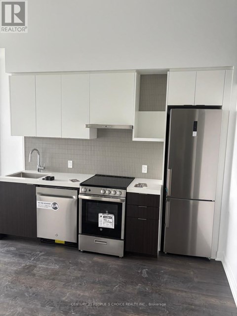 A kitchen with a stainless steel refrigerator and oven.