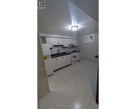 A kitchen with white cabinets and appliances.