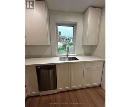 A kitchen with white cabinets and a stainless steel dishwasher.