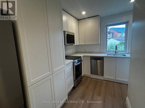 A kitchen with white cabinets and a stainless steel dishwasher.