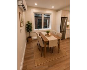 A dining room with a table set for four.