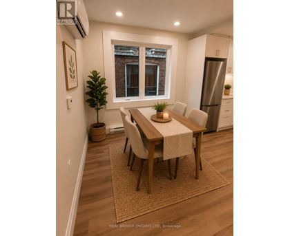 A dining room with a table set for four.