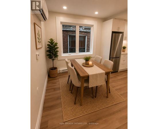 A dining room with a table set for four.