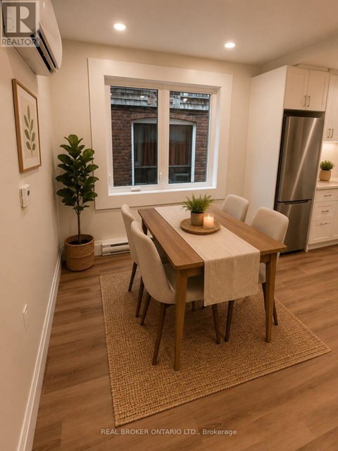 A dining room with a table set for four.
