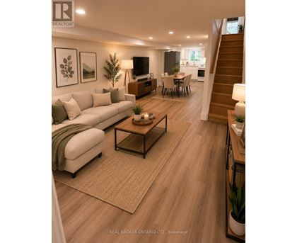 A well-lit living room with a staircase leading to the upper floor.