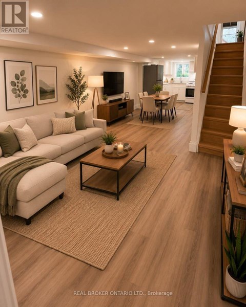 A well-lit living room with a staircase leading to the upper floor.