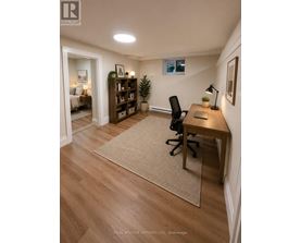 A kitchen with wooden floors and white cabinets.