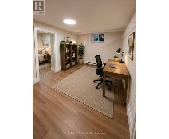 A kitchen with wooden floors and white cabinets.