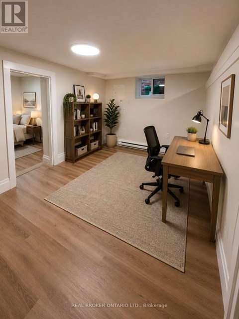 A kitchen with wooden floors and white cabinets.