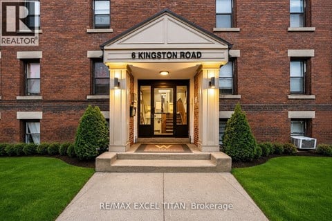 The front entrance of a building with a sign that reads "6 Kingston Road".