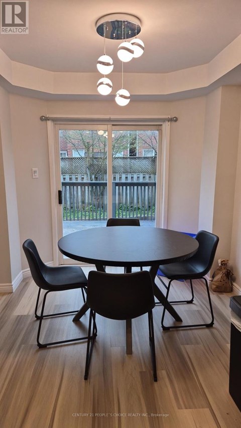 A dining room with a table and chairs.