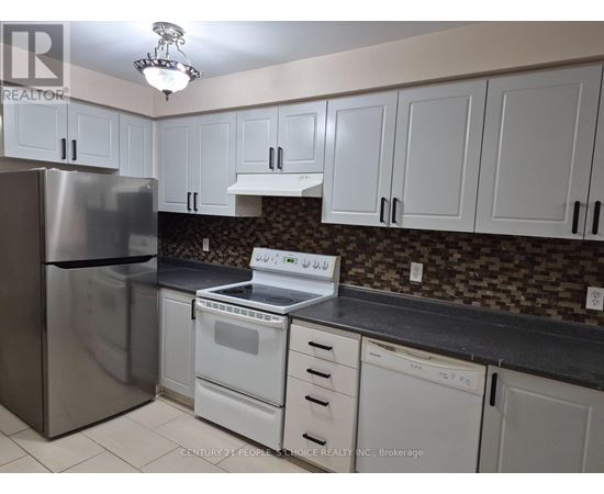 A kitchen with white cabinets and a stainless steel refrigerator.