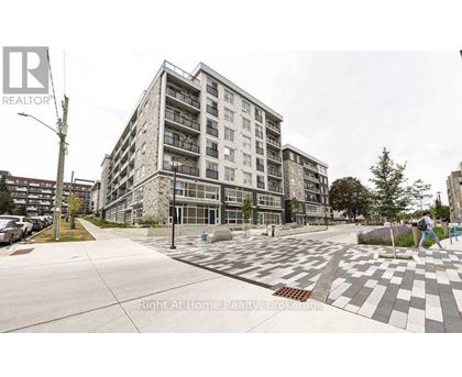 A large apartment building with a parking lot in front.