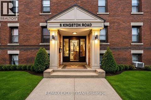 The front entrance of a building with a sign that reads "6 Kingston Road".