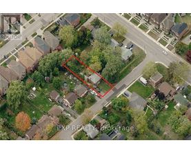 An aerial view of a neighborhood with a red outlined property.