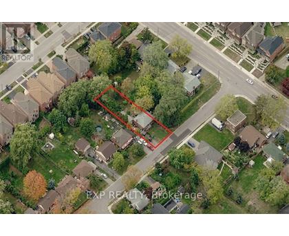 An aerial view of a neighborhood with a red outlined property.