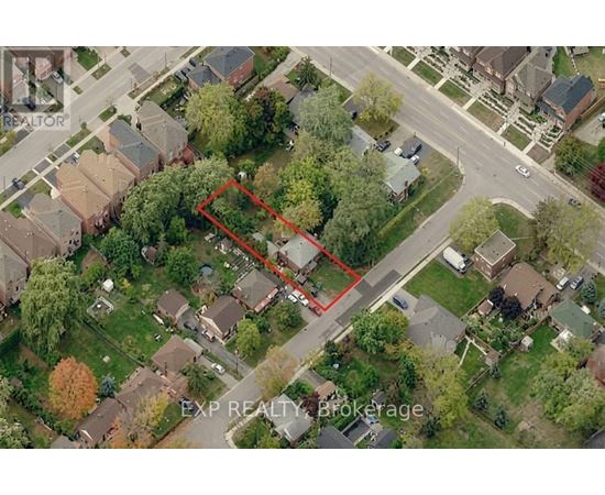 An aerial view of a neighborhood with a red outlined property.