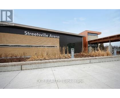 The front of the Streetsville Arena building with a sign that says EXP REALTY Brokerage.
