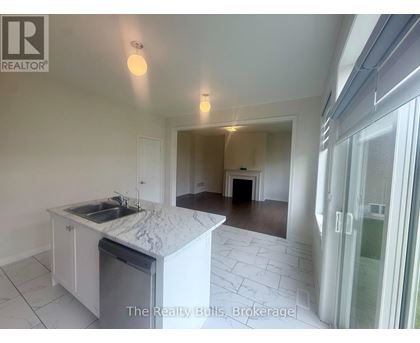 A kitchen with a marble countertop and a sink is shown in a real estate listing.