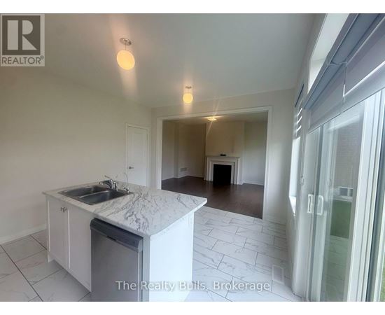 A kitchen with a marble countertop and a sink is shown in a real estate listing.