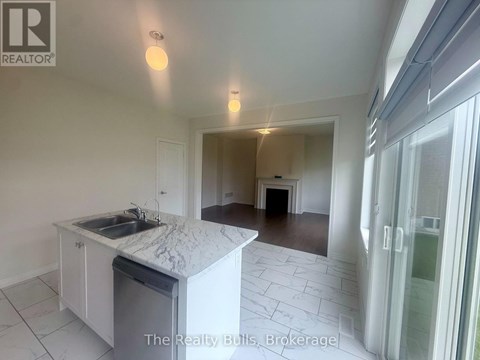 A kitchen with a marble countertop and a sink is shown in a real estate listing.