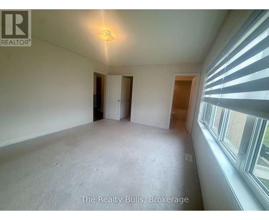 A room with a window on the right side and a door on the left side.