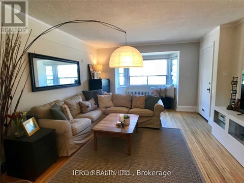 A living room with a large sectional sofa and a coffee table.