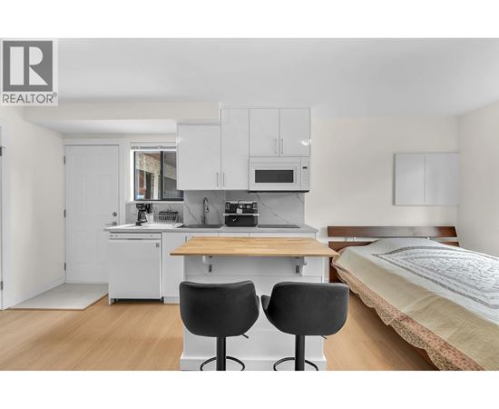 A bedroom with a bed, desk, and chair.
