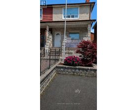 A house with a white door and a small garden in front.