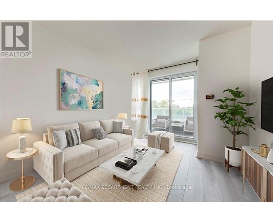 A living room with a white couch, a coffee table, and a painting on the wall.