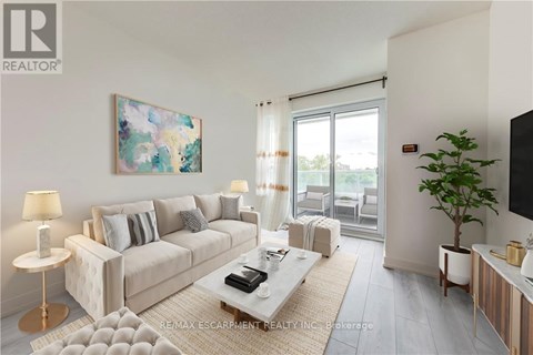 A living room with a white couch, a coffee table, and a painting on the wall.