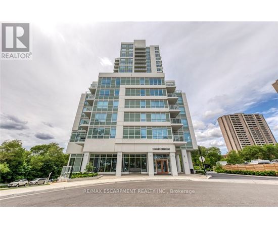 A modern building with the sign "RE/MAX ESCARPMENT REALTY INC." in front of it.