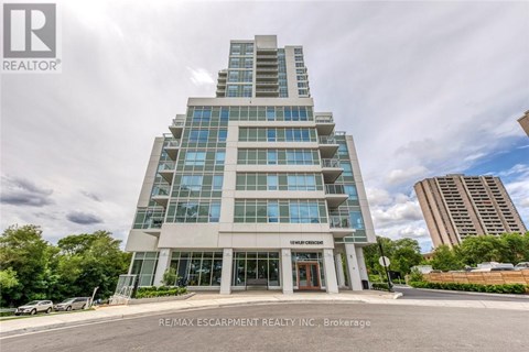 A modern building with the sign "RE/MAX ESCARPMENT REALTY INC." in front of it.