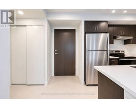 A kitchen with a refrigerator covered in magnets.