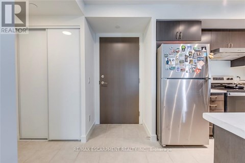 A kitchen with a refrigerator covered in magnets.