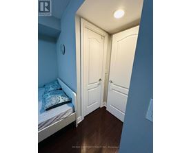 A bedroom with a bed and a door.