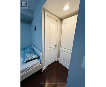 A bedroom with a bed and a door.