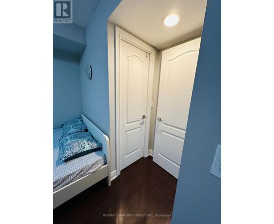 A bedroom with a bed and a door.