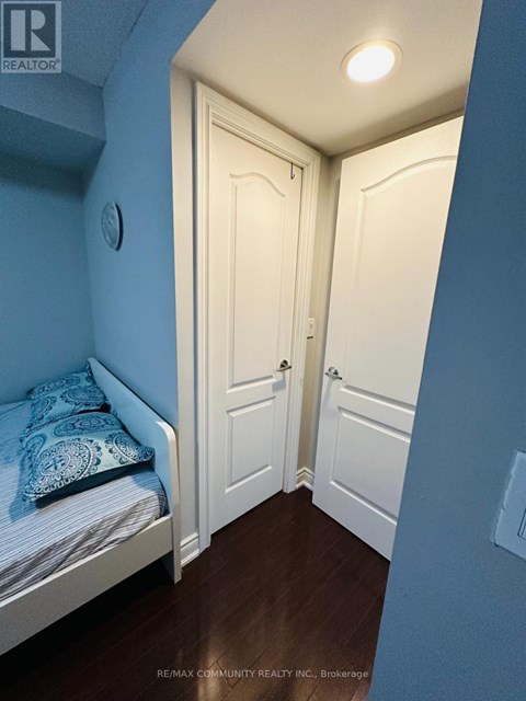 A bedroom with a bed and a door.